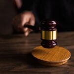 A wooden gavel on a wooden table