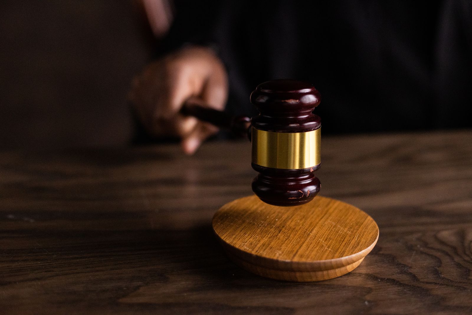 A wooden gavel on a wooden table