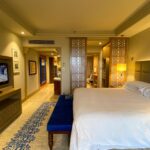 A spacious modern hotel room with a large bed