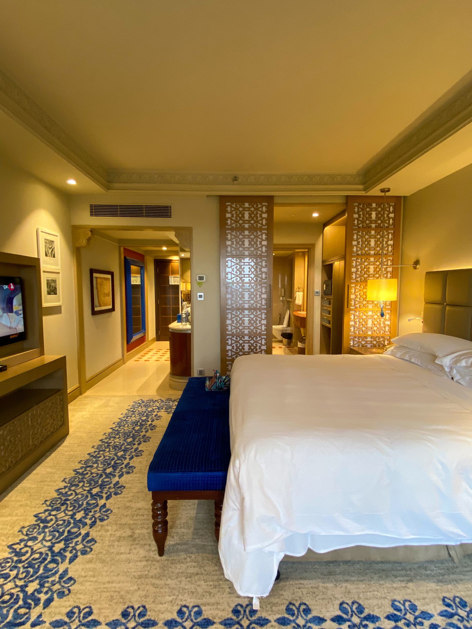 A spacious modern hotel room with a large bed